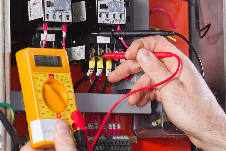 Electrician testing a fuse board